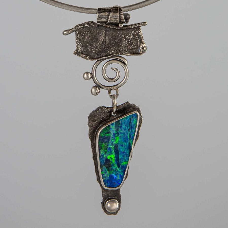 Silver pendant with a dark blue opal
