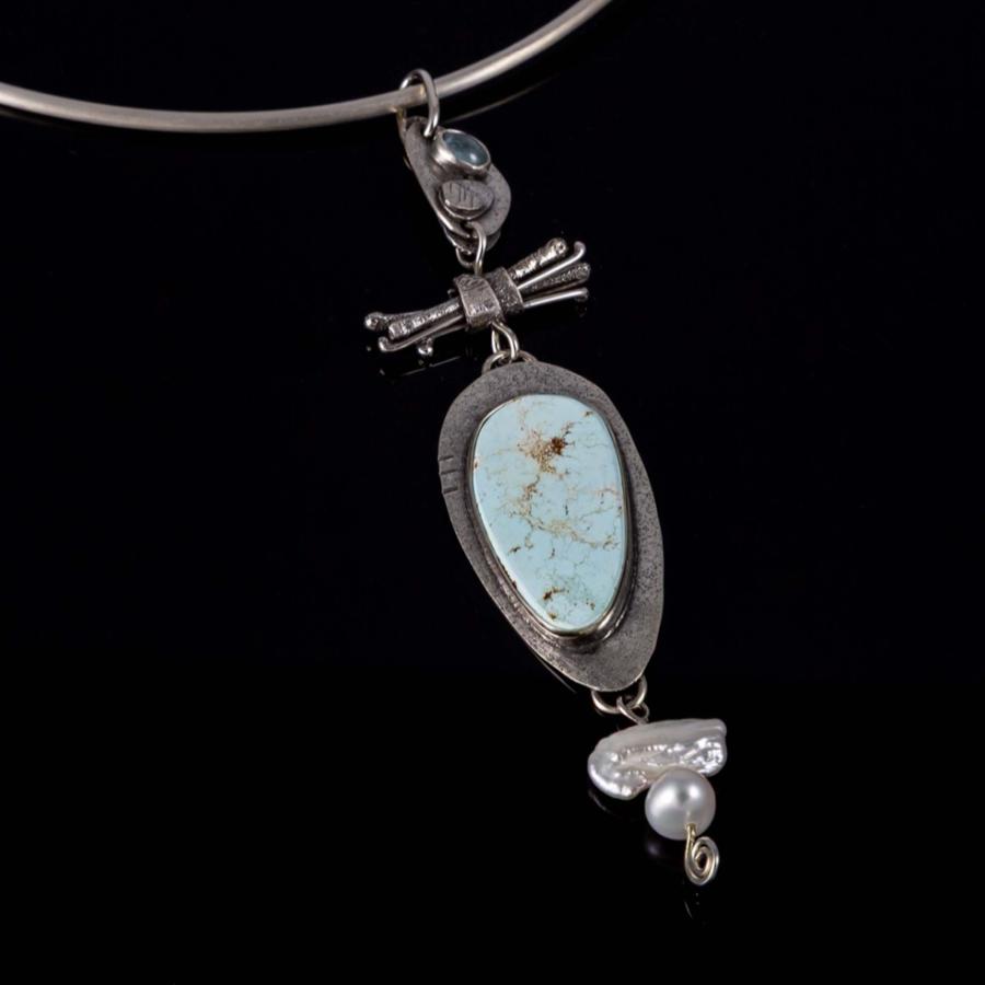 Silver pendant with a blue stone and pearls