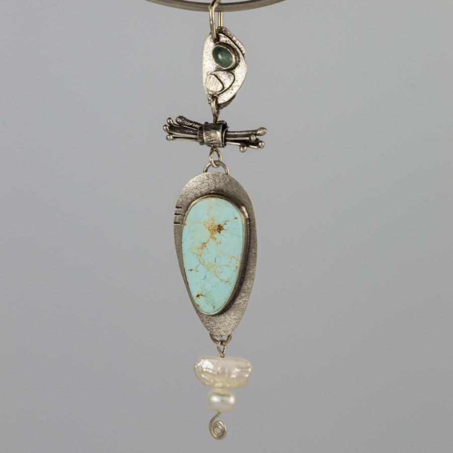 Silver pendant with a blue stone and pearls