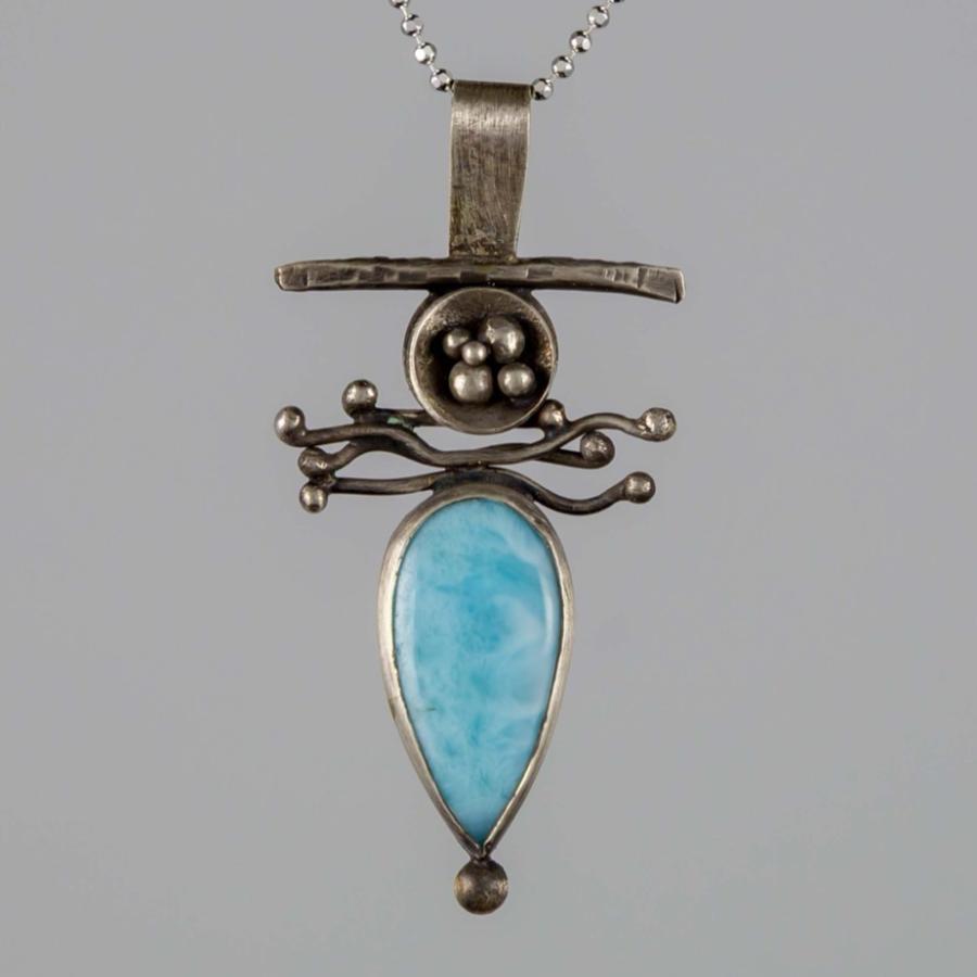Silver pendant with a blue stone