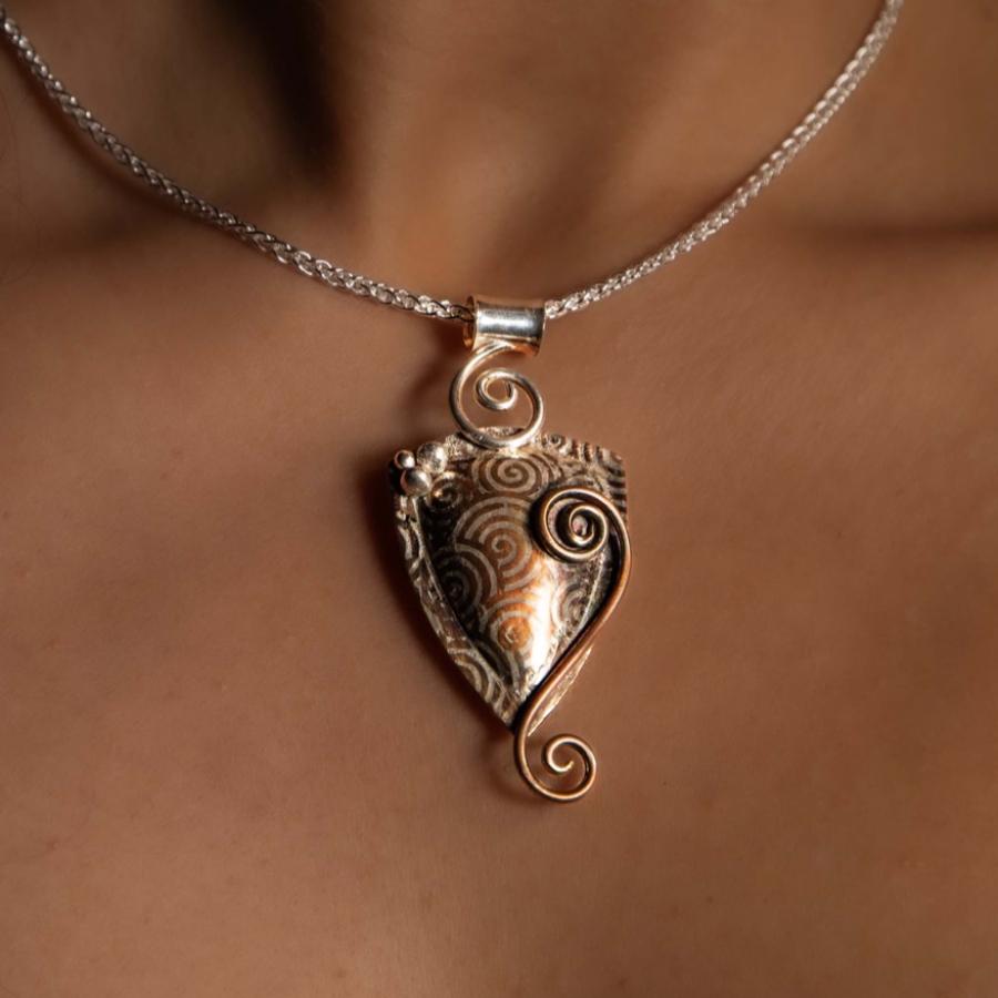 Model wearing a silver and copper pendant