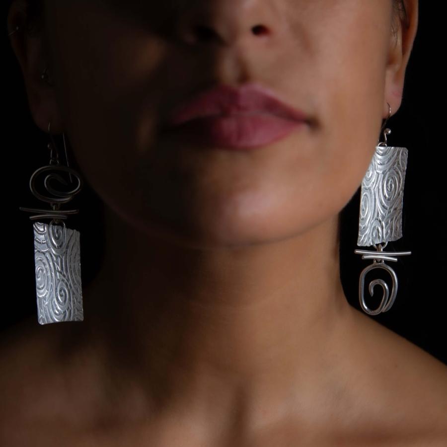 Model wearing silver earrings