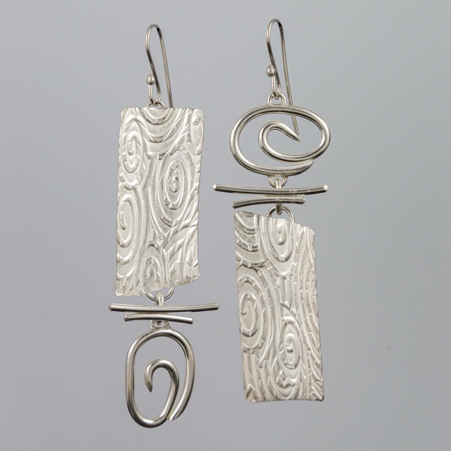 Silver earrings with a swirl pattern