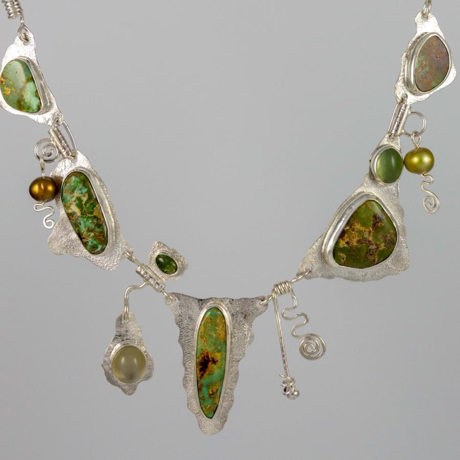 Silver necklace with multiple green stones