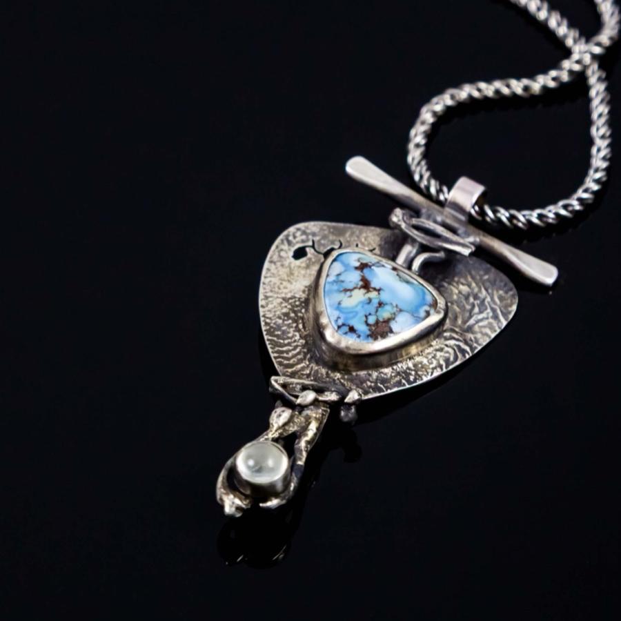 Silver pendant with a pale blue stone