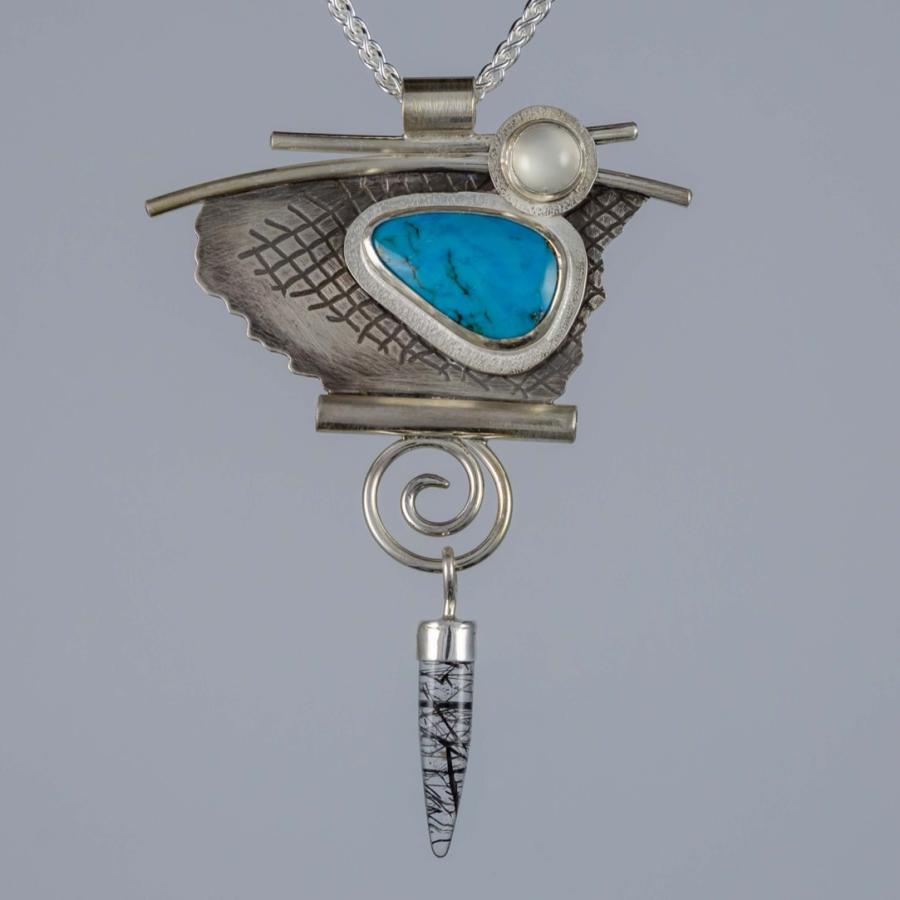Silver pendant with a blue stone