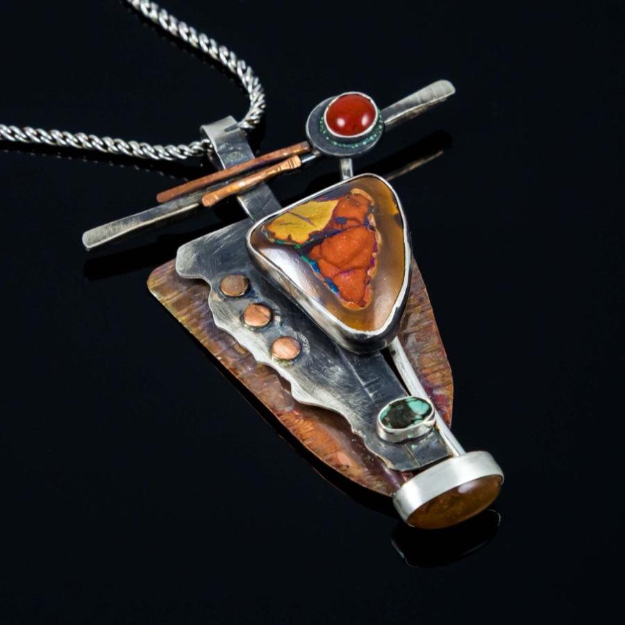 Silver and coper pendant with multiple orange and green stones