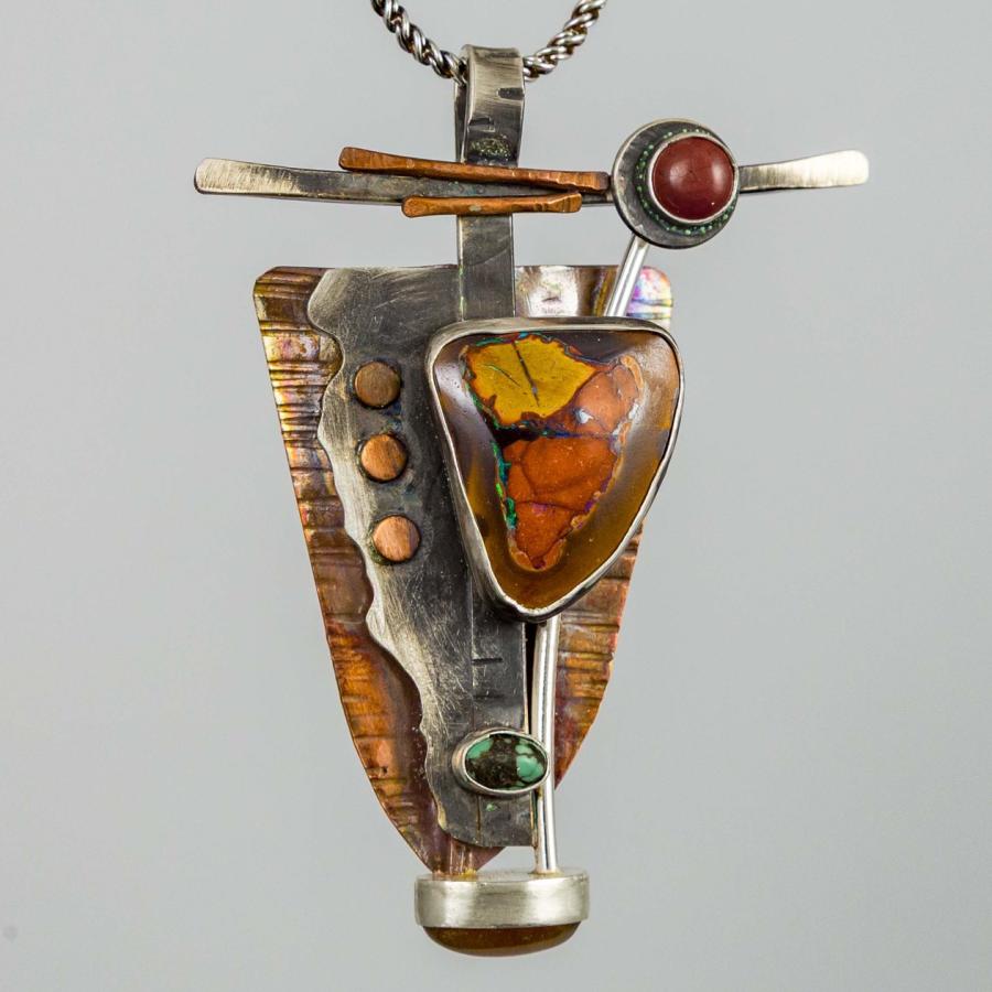 Silver and coper pendant with multiple orange and green stones