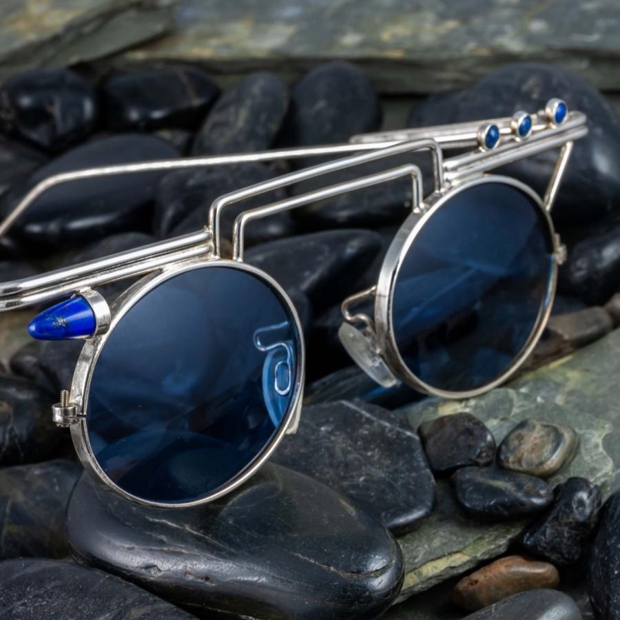 Unique silver glasses with blue stones and blue lenses.