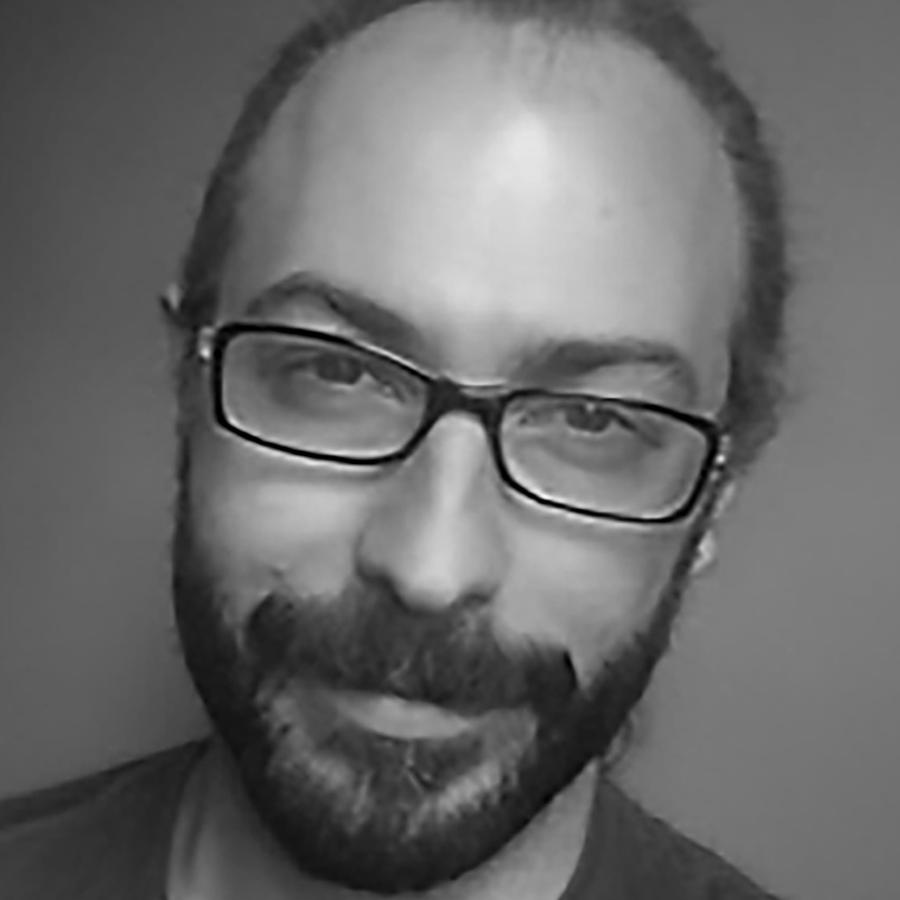 A man with a beard and glasses