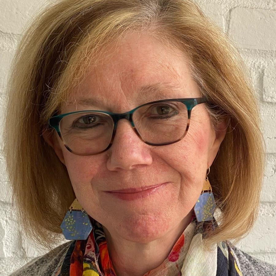 A smiling woman with glasses