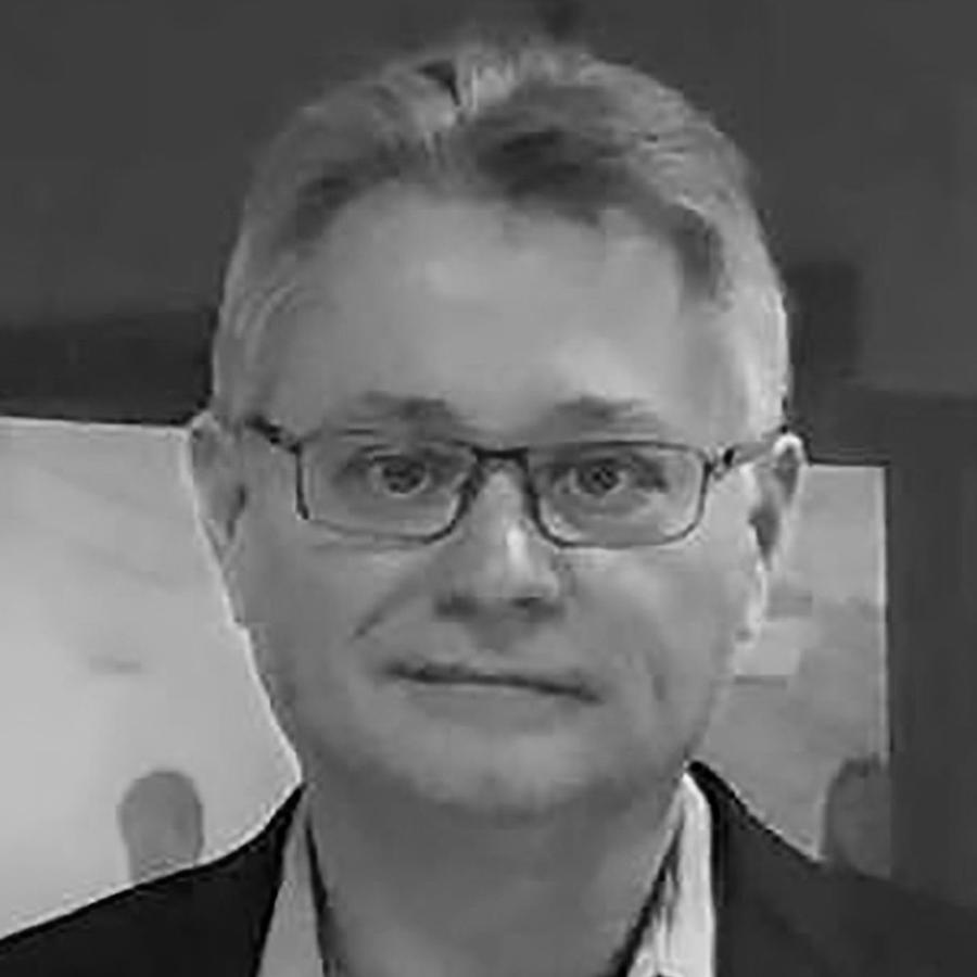 A black and white photo of a man with glasses