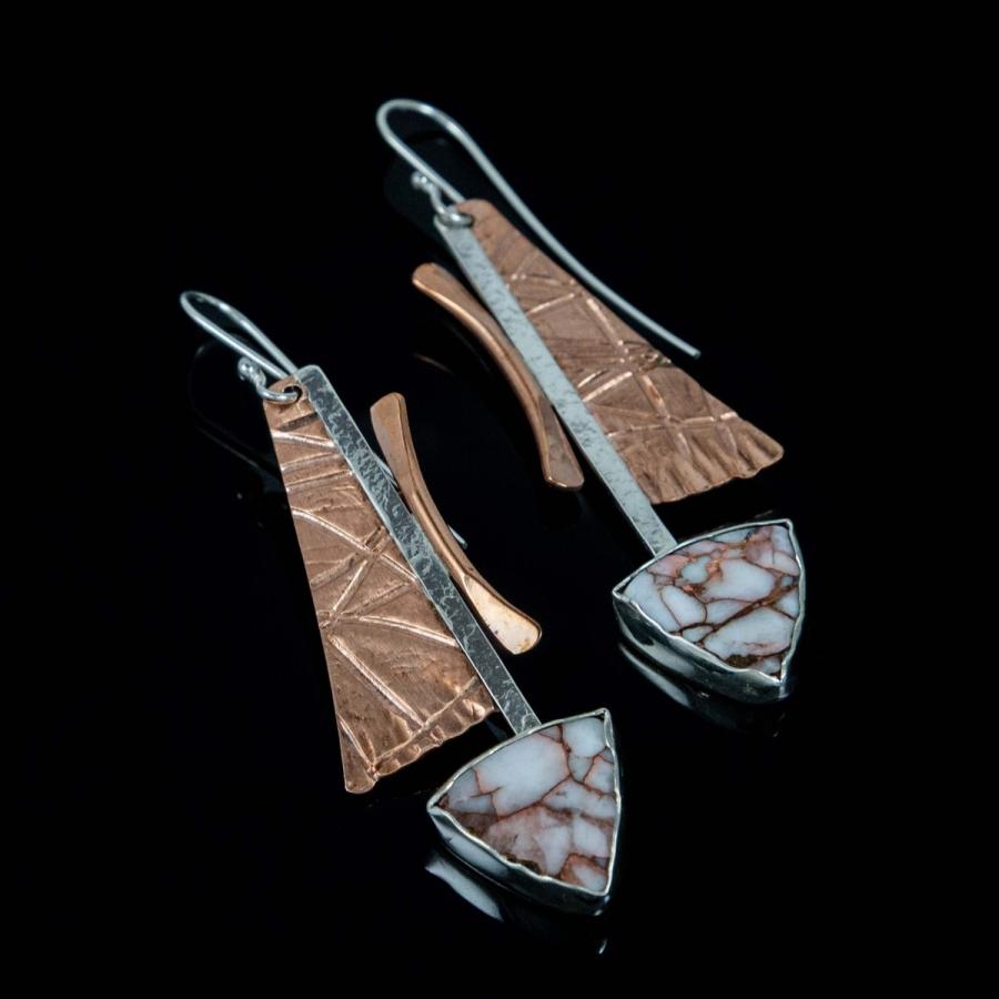 Pair of geometric dangle earrings with textured copper panels and triangular stone accents.