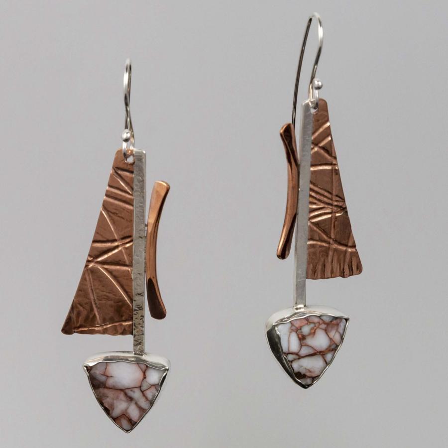 Pair of geometric dangle earrings with textured copper panels and triangular stone accents.