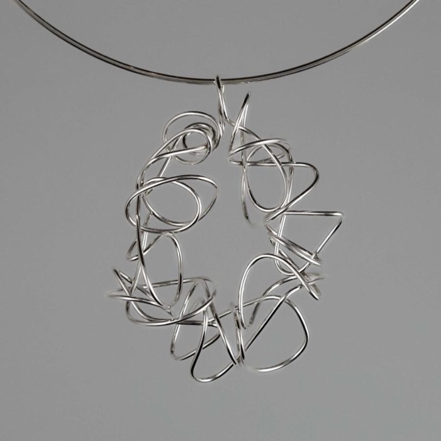 Silver wire necklace with an abstract, tangled pendant on a thin silver collar.
