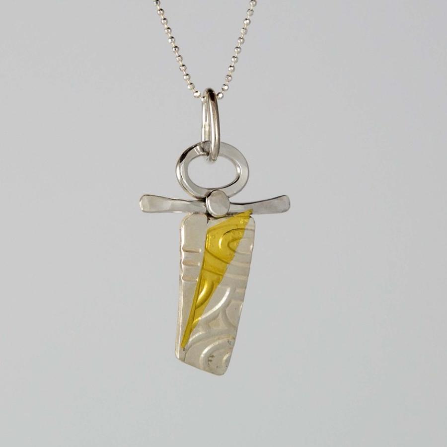 A silver necklace with a unique, textured silver and gold-accented pendant.