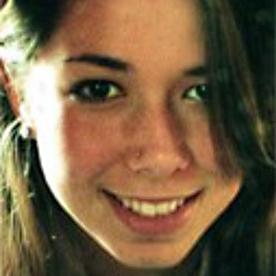 Close-up photograph of a smiling young woman with dark hair.