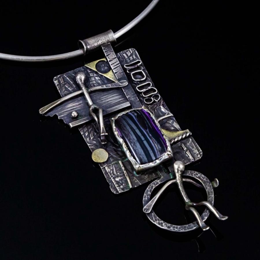 A textured silver pendant featuring a rectangular violet stone on a simple wire necklace.