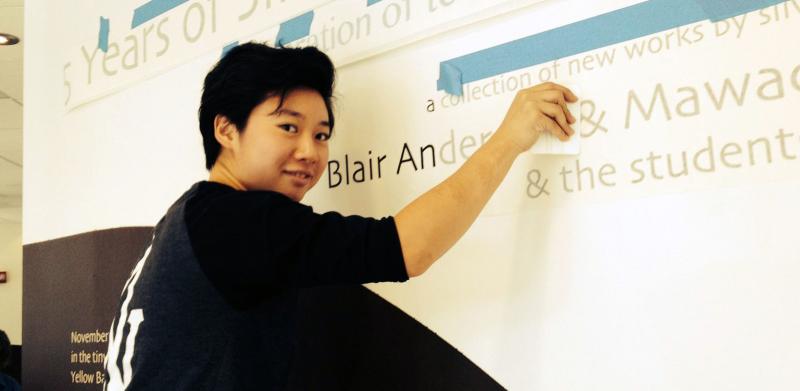 Kelly putting up vinyl text