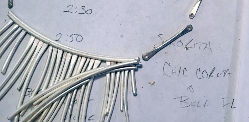 necklace parts in process, laid out on concept sketch