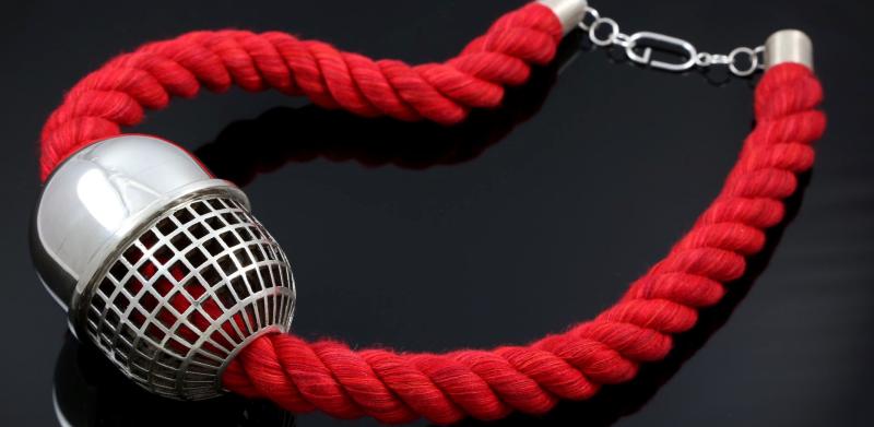 necklace with red rope and cage pill-like centerpiece