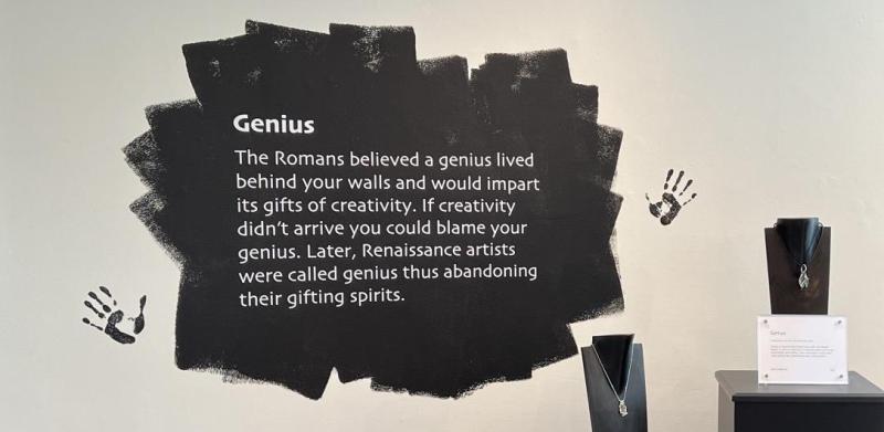 Quote about Genius painted on white wall