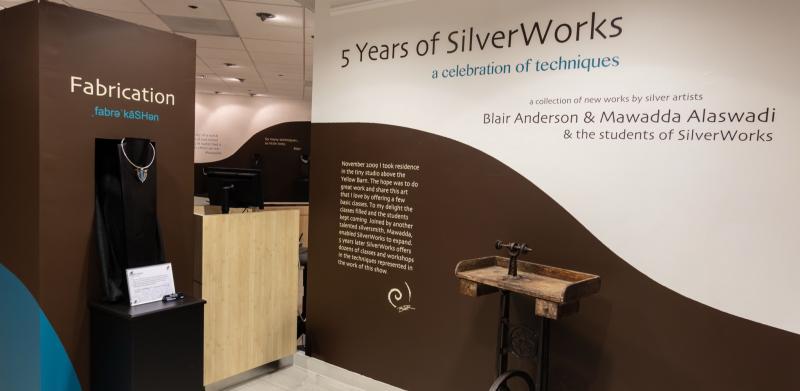 Gallery display with jewelry and historical information.