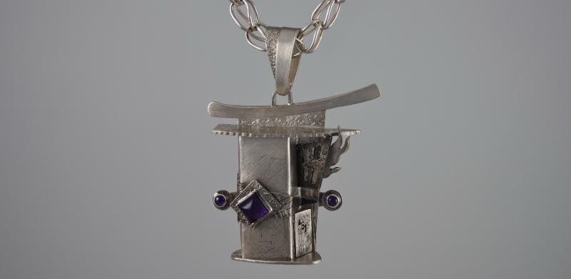 Silver necklace with abstract pendant.
