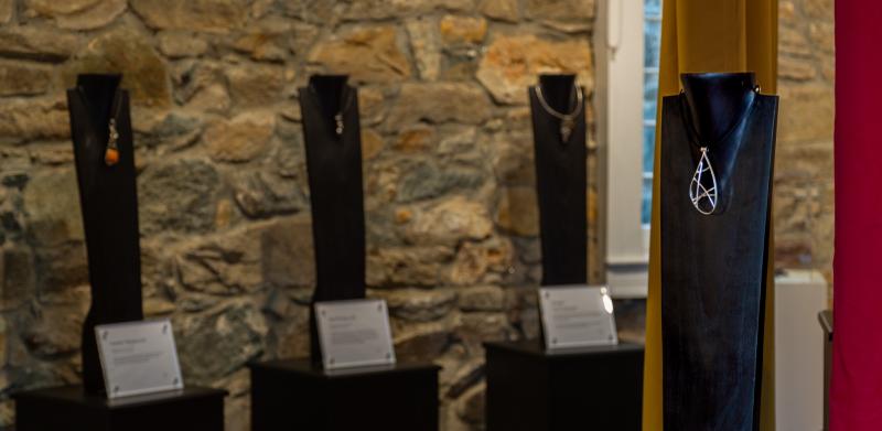 Art installation featuring jewelry on busts