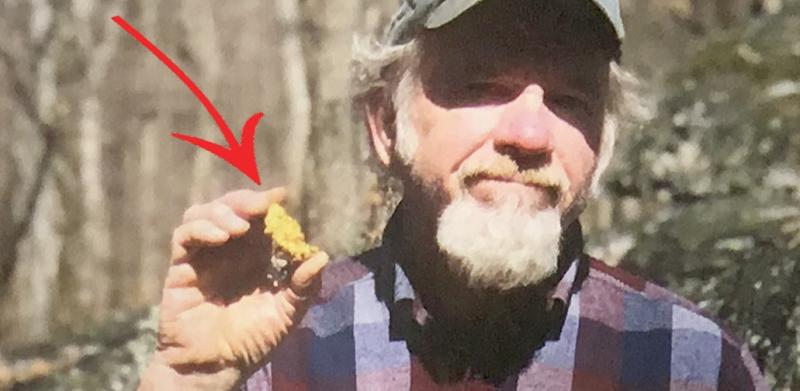 Man holding a gold nugget
