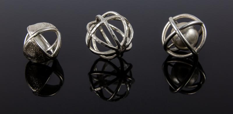 Three silver cage spheres