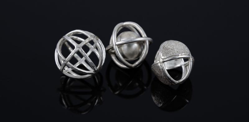 Three silver cage spheres