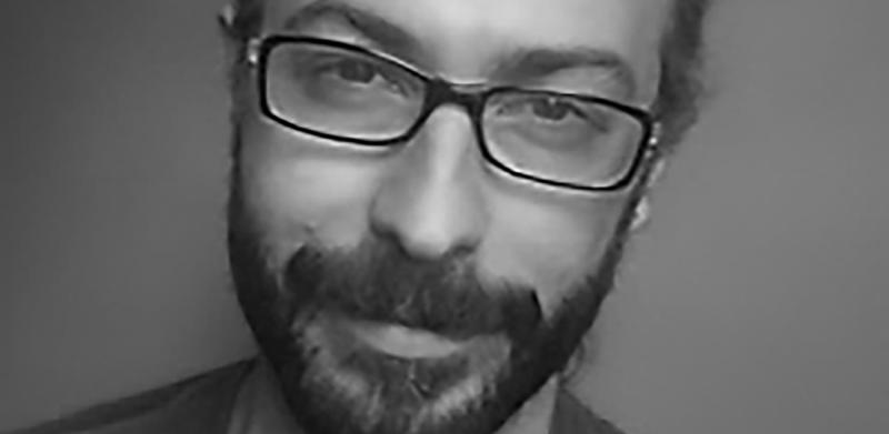 A man with a beard and glasses