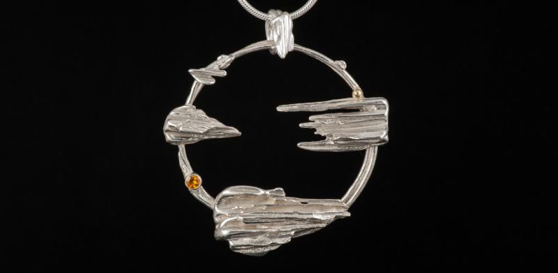 Unique silver pendant with a yellow stone