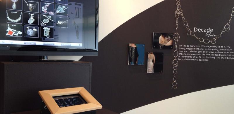 Interactive jewelry kiosk with a digital catalog display and a small touchscreen console.