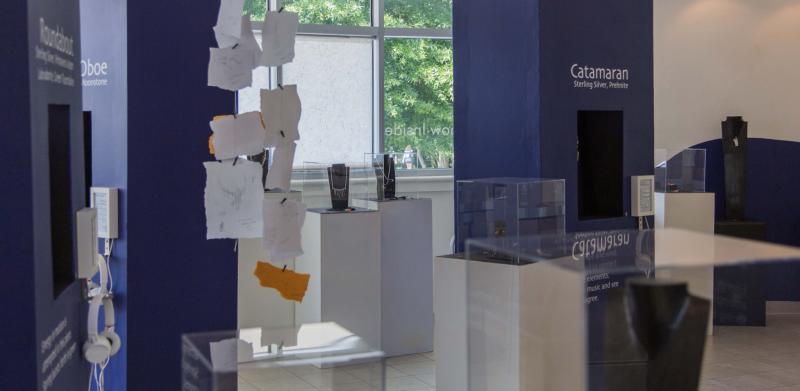 Photograph of a museum exhibit with blue display pillars and glass cases.