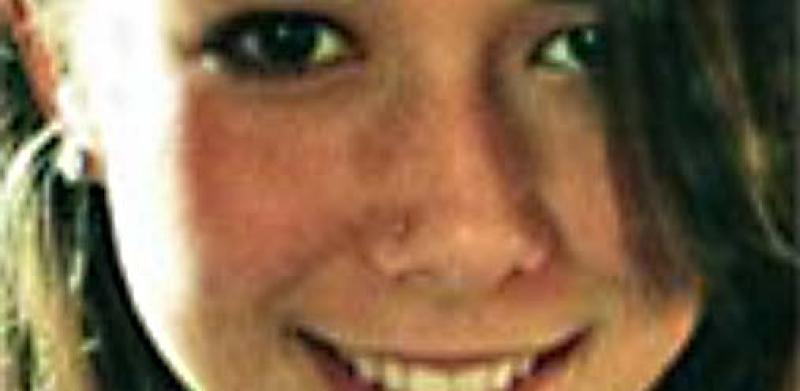 Close-up photograph of a smiling young woman with dark hair.