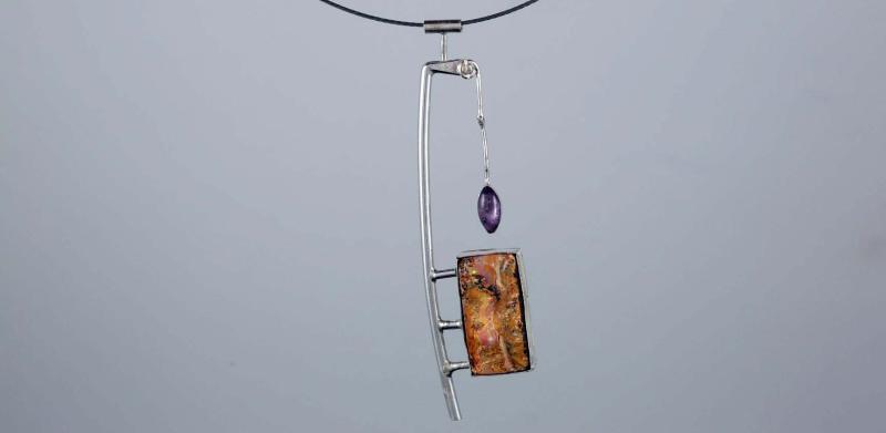Abstract silver necklace with a rectangular amber pendant and a small purple amethyst drop.
