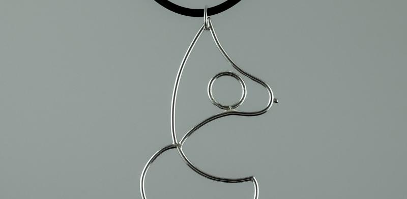 Silver wire outline pendant of a woman's body on a black cord.