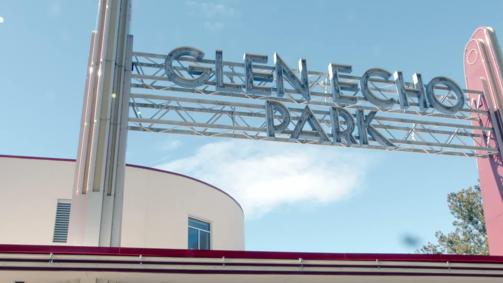 Photograph of the Glen Echo Park entrance sign against a blue sky.