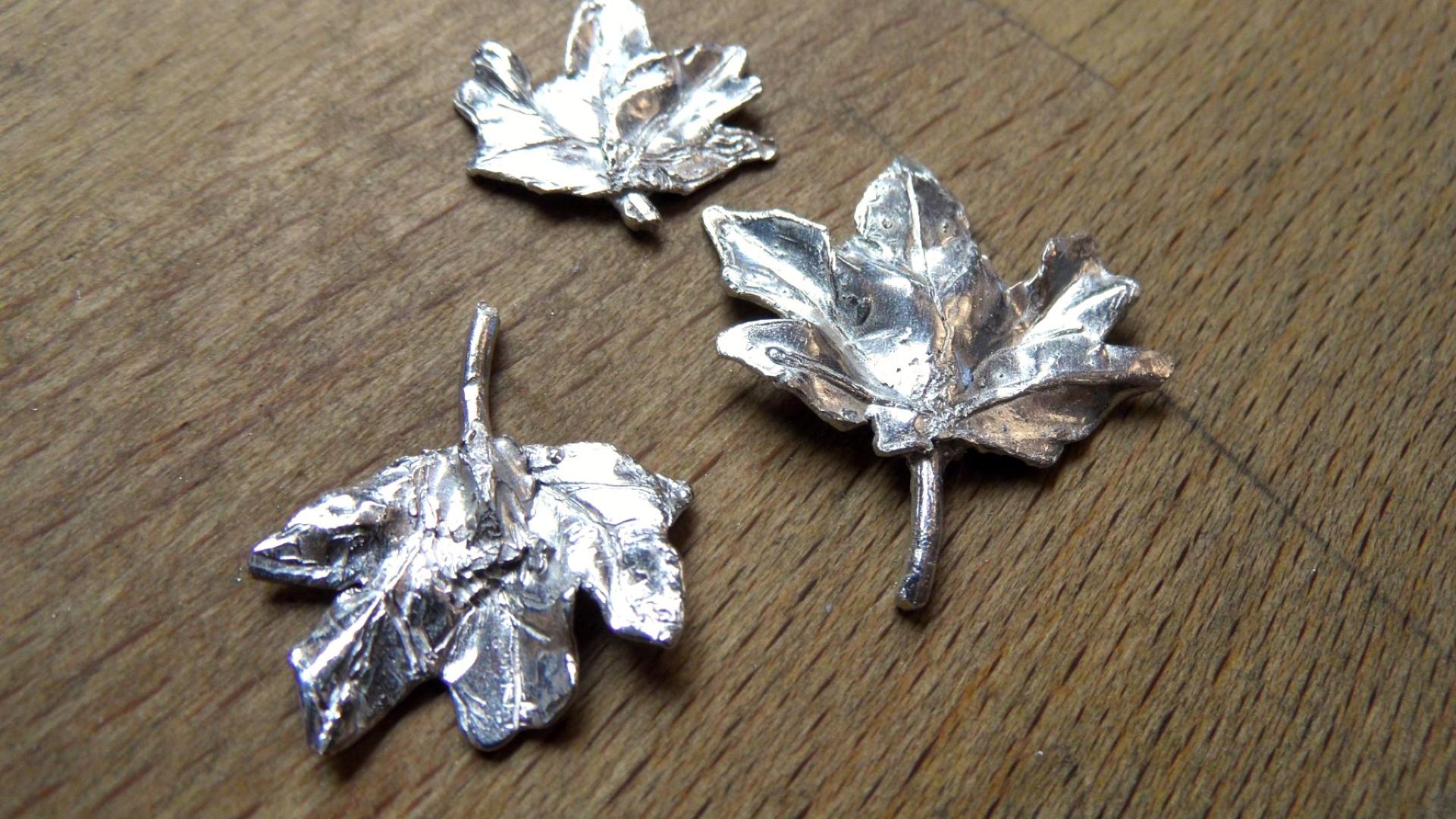 Three silver cast carved leaves