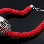 necklace with red rope and cage pill-like centerpiece 