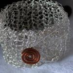 crocheted silver wire cuff with copper spiral button