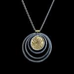 A silver pendant with gold accents