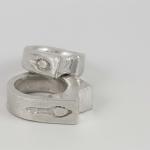 Two stacked silver rings with an etched symbols.