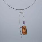 Abstract silver necklace with a rectangular amber pendant and a small purple amethyst drop.