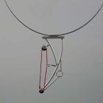 Minimalist silver wire necklace with a red looped accent and geometric details.