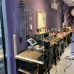 Interior photograph of a jewelry store featuring a clear acrylic protective barrier on a checkout desk.