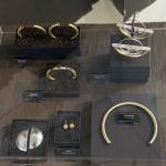Photograph of jewelry pieces displayed inside a glass showcase.