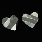 Two silver heart-shaped metal pieces with folded lines, set against a solid black background.